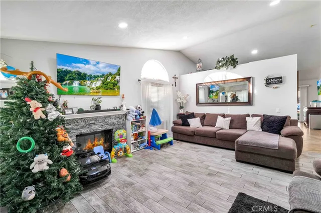a living room with furniture flowers and a potted plant