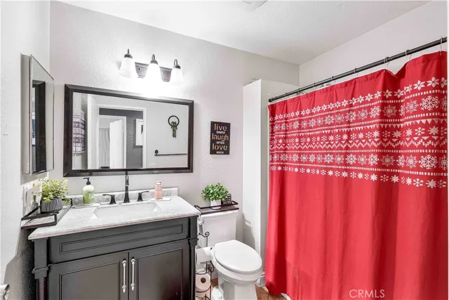 a bedroom with a bed window and a dresser