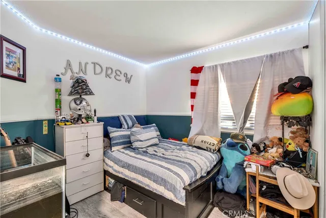 a bedroom with a bed and a potted plant