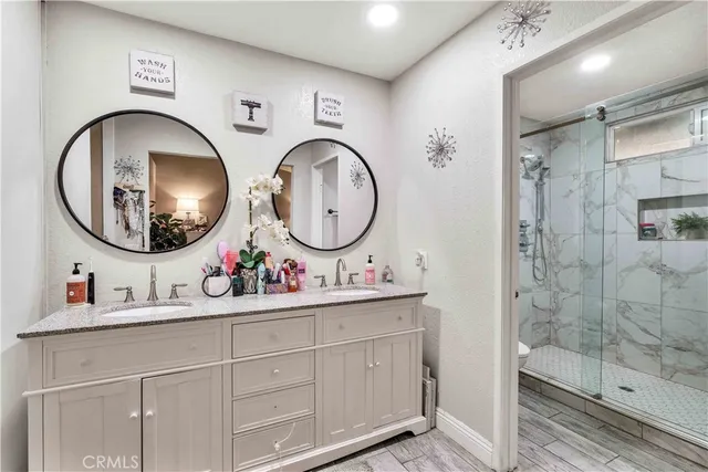 a bathroom with a shower a toilet and a sink