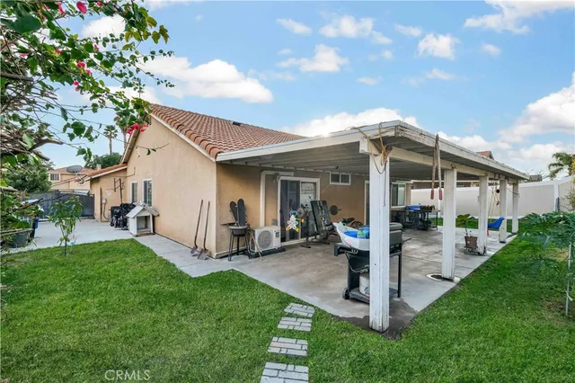 a front view of house with a garden and plants