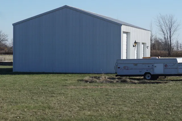 a view of a lake with a big yard and large trees