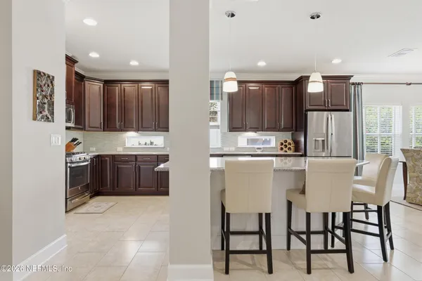 a kitchen with stainless steel appliances granite countertop a sink stove and cabinets
