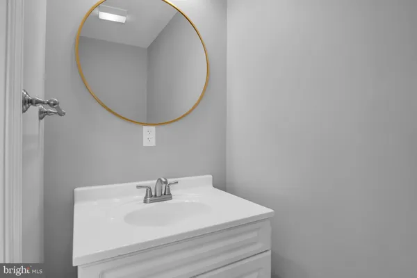 a bathroom with a sink a mirror and vanity