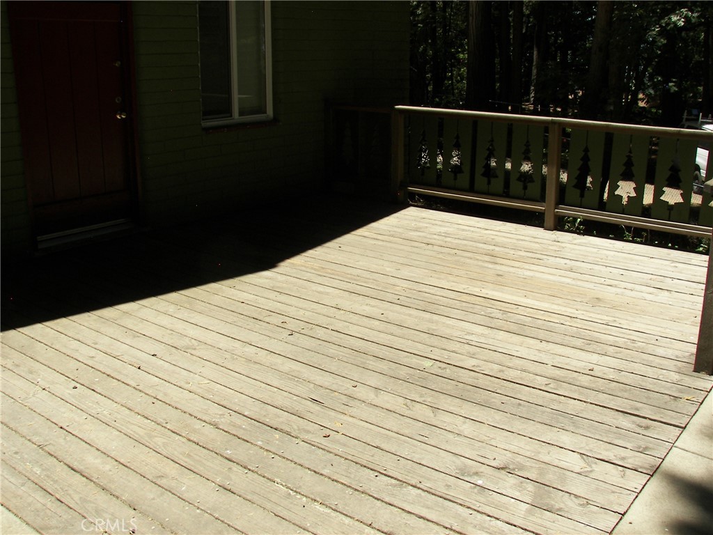 1101 Big Tree Lane Crestline, CA 92325 - Photo 4 of 30 a bed sitting in a bedroom next to a yard