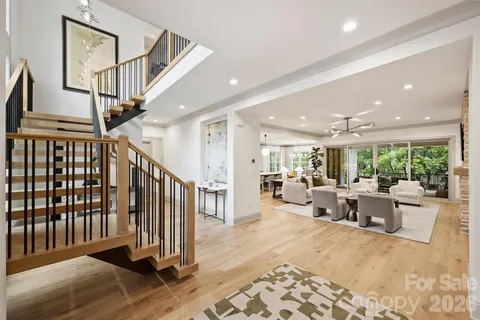 a living room with lots of furniture and a large window