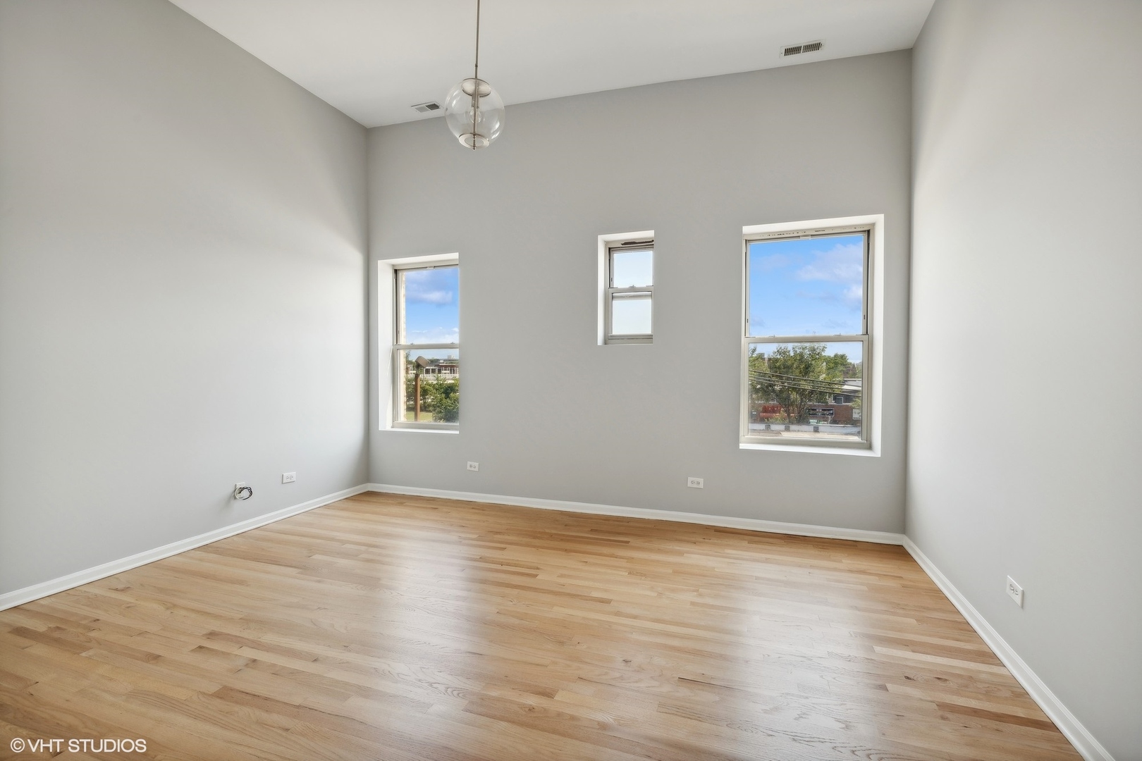 4646 South Prairie Avenue, Unit 3S Chicago, IL 60653 - Photo 12 of 42 an empty room with wooden floor and windows
