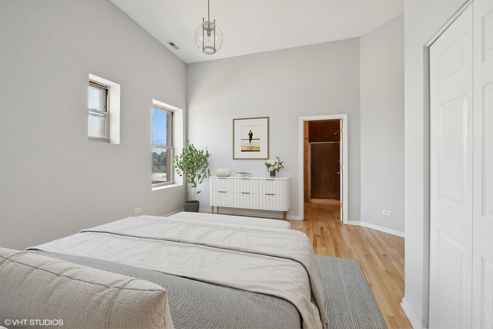 4646 South Prairie Avenue, Unit 3S Chicago, IL 60653 - Photo 15 of 42 a bedroom with a large bed and a chandelier