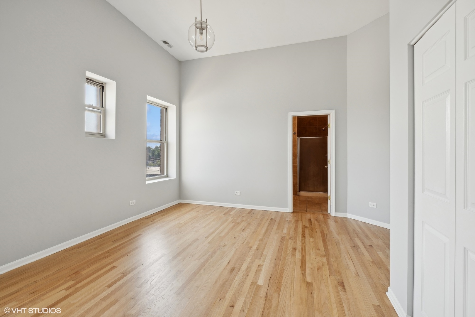 4646 South Prairie Avenue, Unit 3S Chicago, IL 60653 - Photo 16 of 42 a view of an empty room with wooden floor and a window