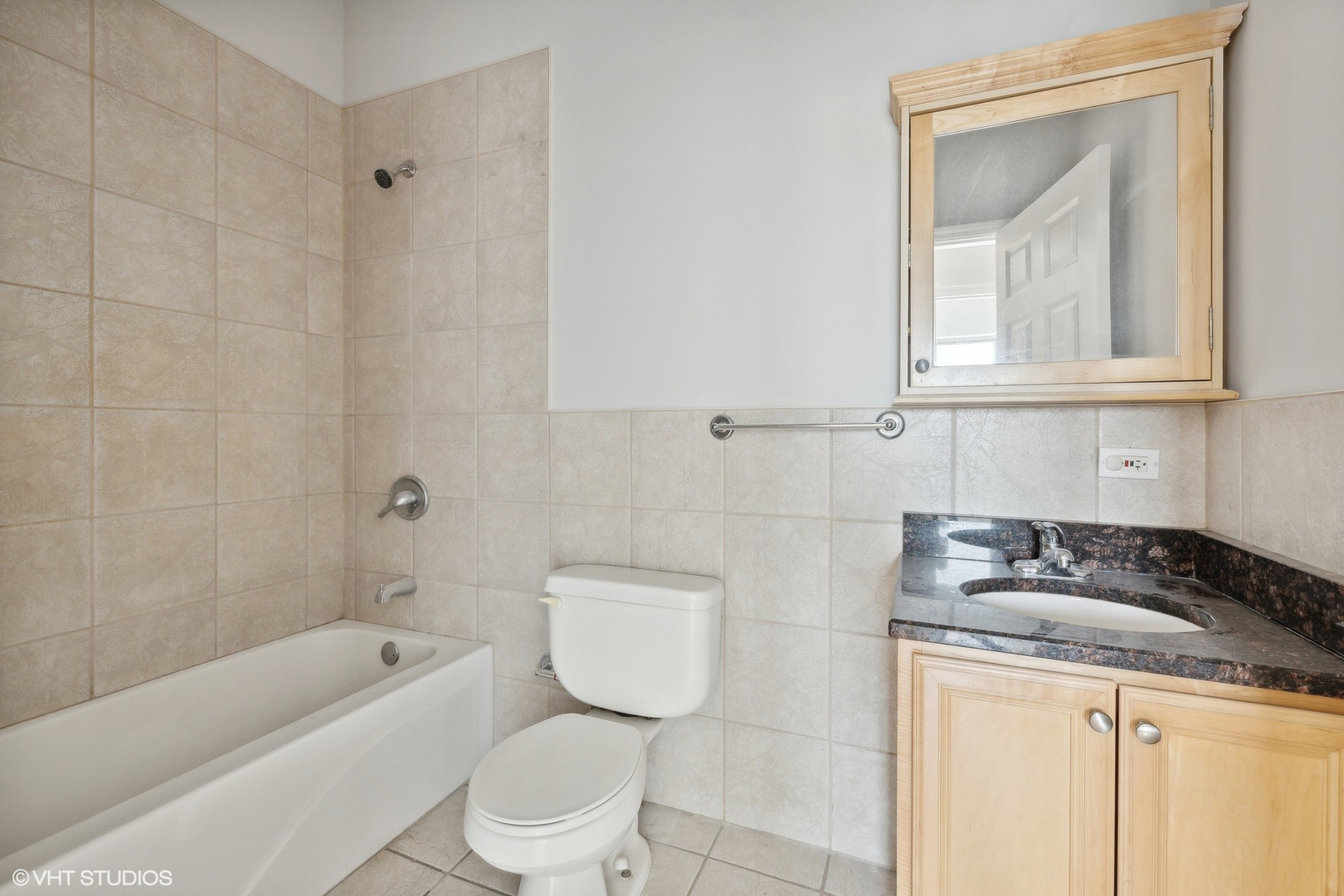 4646 South Prairie Avenue, Unit 3S Chicago, IL 60653 - Photo 26 of 42 a bathroom with a granite countertop toilet a sink and bathtub