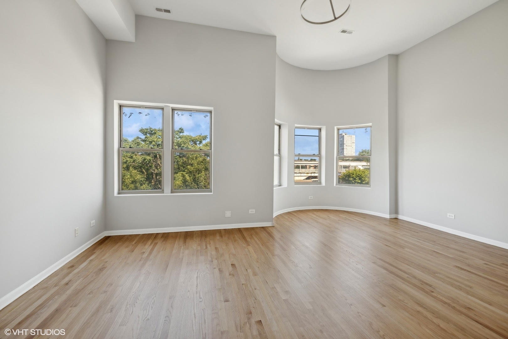 4646 South Prairie Avenue, Unit 3S Chicago, IL 60653 - Photo 3 of 42 an empty room with wooden floor and windows