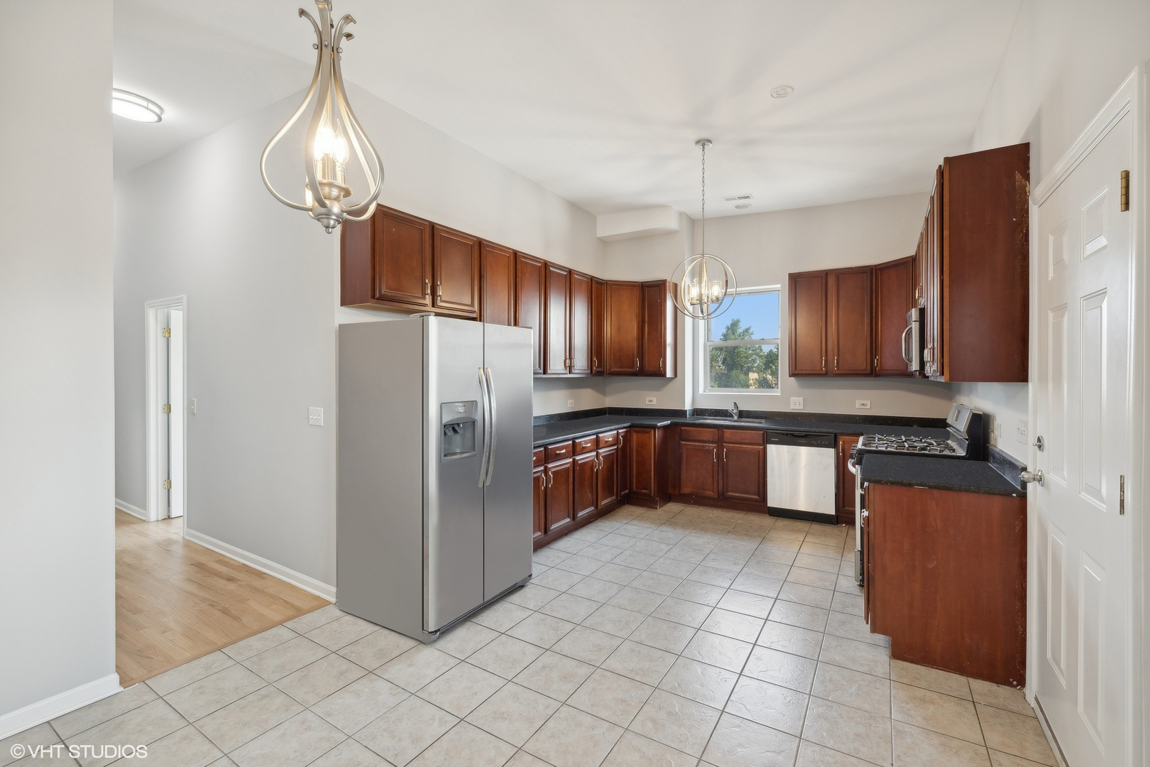 4646 South Prairie Avenue, Unit 3S Chicago, IL 60653 - Photo 33 of 42 a kitchen with kitchen island granite countertop wooden cabinets and stainless steel appliances