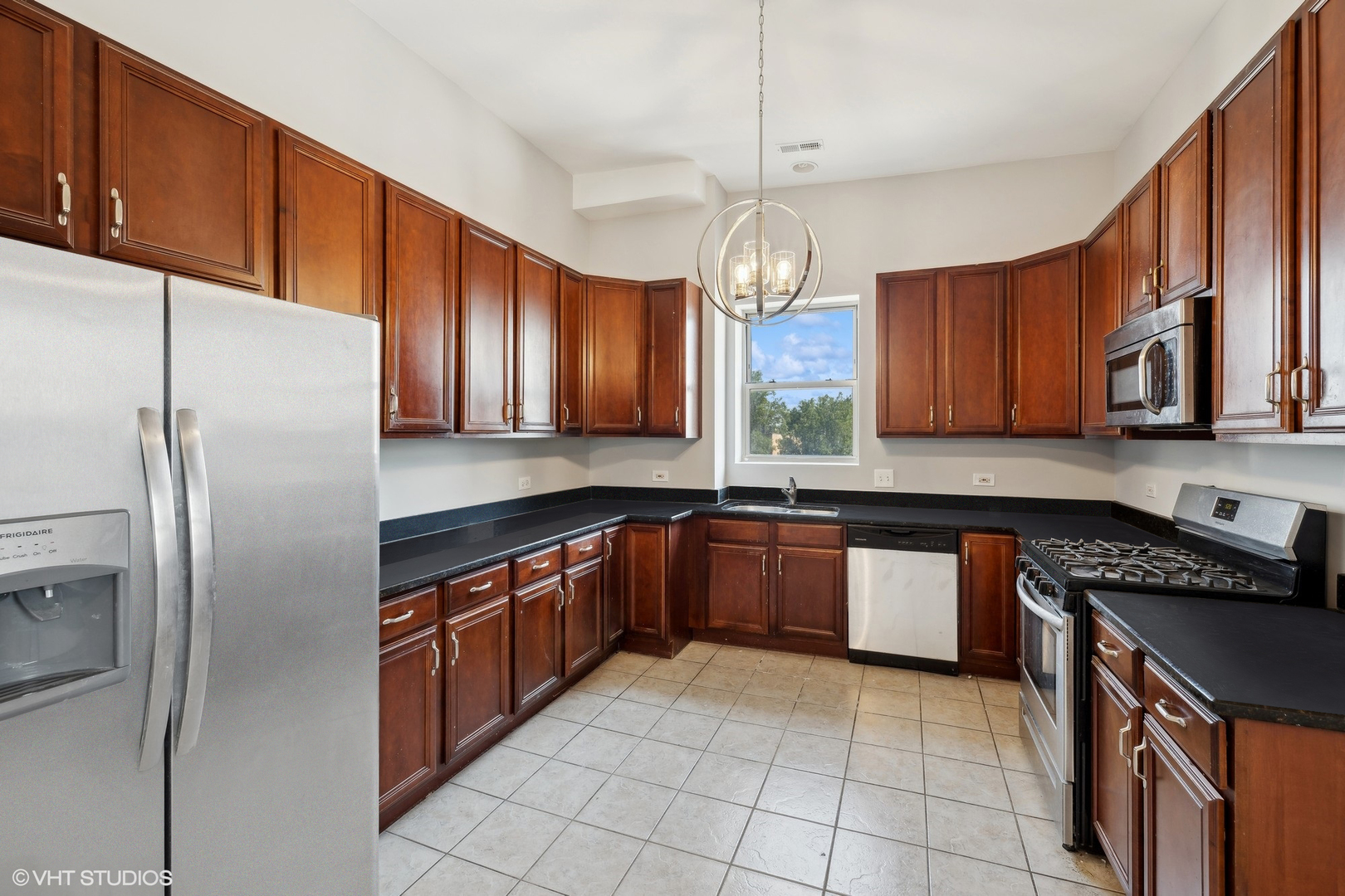 4646 South Prairie Avenue, Unit 3S Chicago, IL 60653 - Photo 36 of 42 a kitchen with stainless steel appliances granite countertop a sink a stove a refrigerator cabinets and a kitchen island