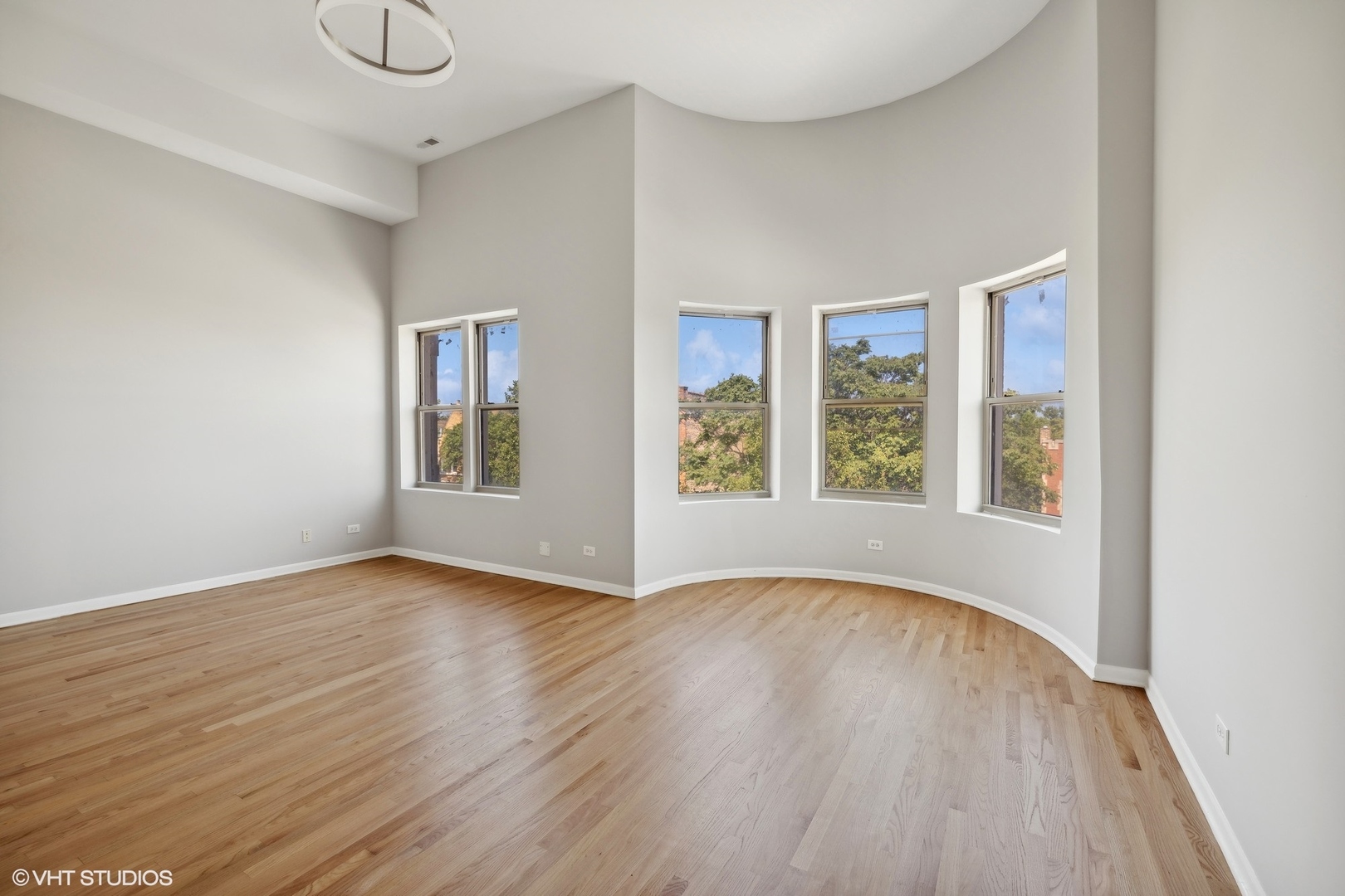 4646 South Prairie Avenue, Unit 3S Chicago, IL 60653 - Photo 5 of 42 a view of an empty room with wooden floor and a window