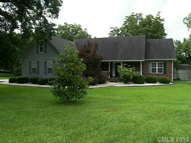 5711 Griffith Road Monroe, NC 28112 - Photo 1 of 16 a front view of a house with a garden