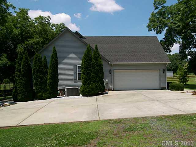 5711 Griffith Road Monroe, NC 28112 - Photo 2 of 16 a house that has a tree in front of it