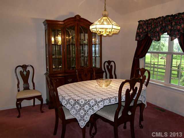 5711 Griffith Road Monroe, NC 28112 - Photo 12 of 16 a view of a dining room with furniture and chandelier