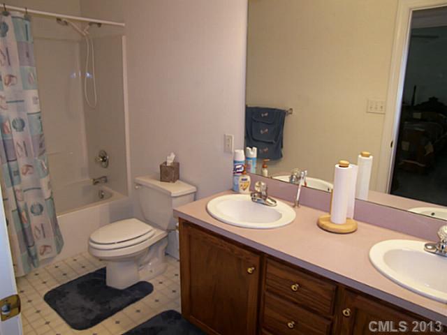 5711 Griffith Road Monroe, NC 28112 - Photo 13 of 16 a bathroom with a double vanity sink toilet and a mirror