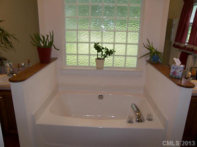 5711 Griffith Road Monroe, NC 28112 - Photo 15 of 16 a bathroom with a bathtub