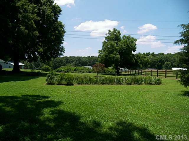 5711 Griffith Road Monroe, NC 28112 - Photo 3 of 16 a view of a big yard with a palm tree