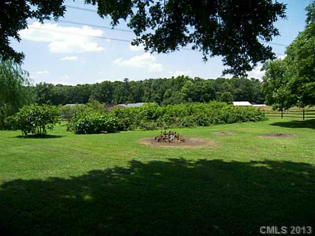 5711 Griffith Road Monroe, NC 28112 - Photo 5 of 16 a view of a golf course with a garden