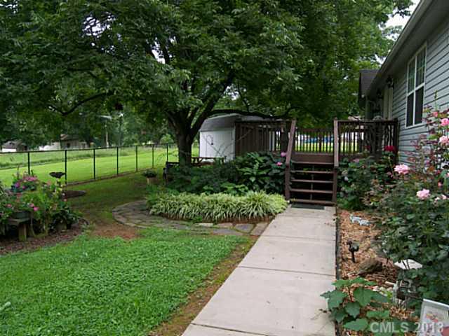 5711 Griffith Road Monroe, NC 28112 - Photo 6 of 16 a front view of a house with a yard and shrubs