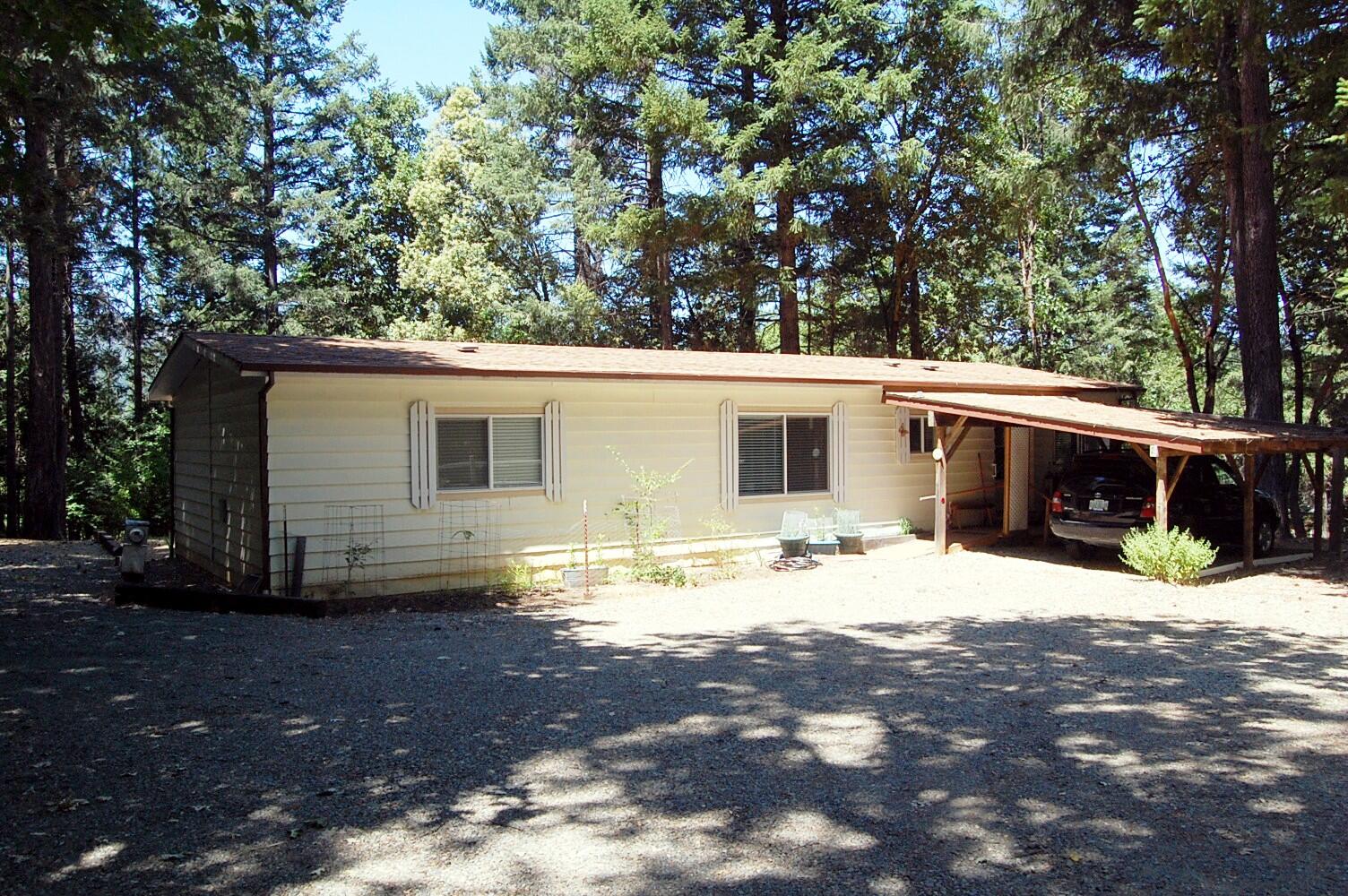 350 Hamilton Avenue Cave Junction, OR 97523 - Photo 1 of 23 a view of a house with a yard