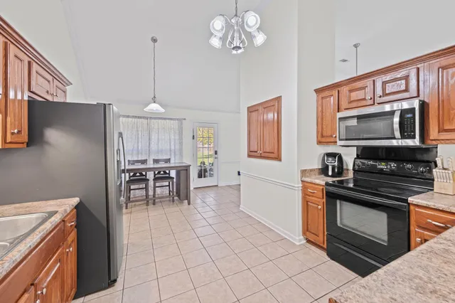 a kitchen with stainless steel appliances granite countertop a stove cabinets and a kitchen island