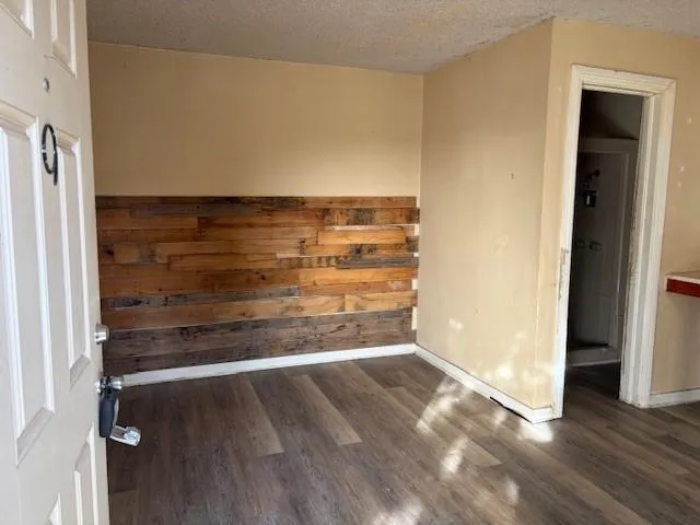 a view of an empty room and wooden floor