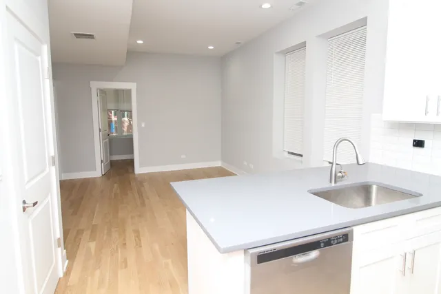 a kitchen with a sink and a refrigerator
