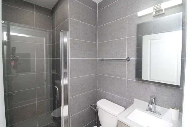 a bathroom with a sink toilet and shower