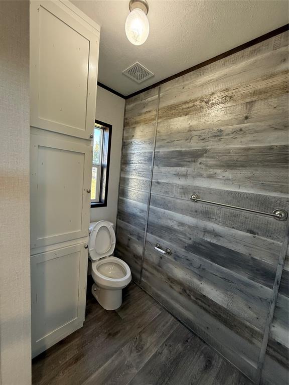 439 Whitefoot Quitman, TX 75783 - Photo 17 of 35 a bathroom with a granite countertop toilet and a shower