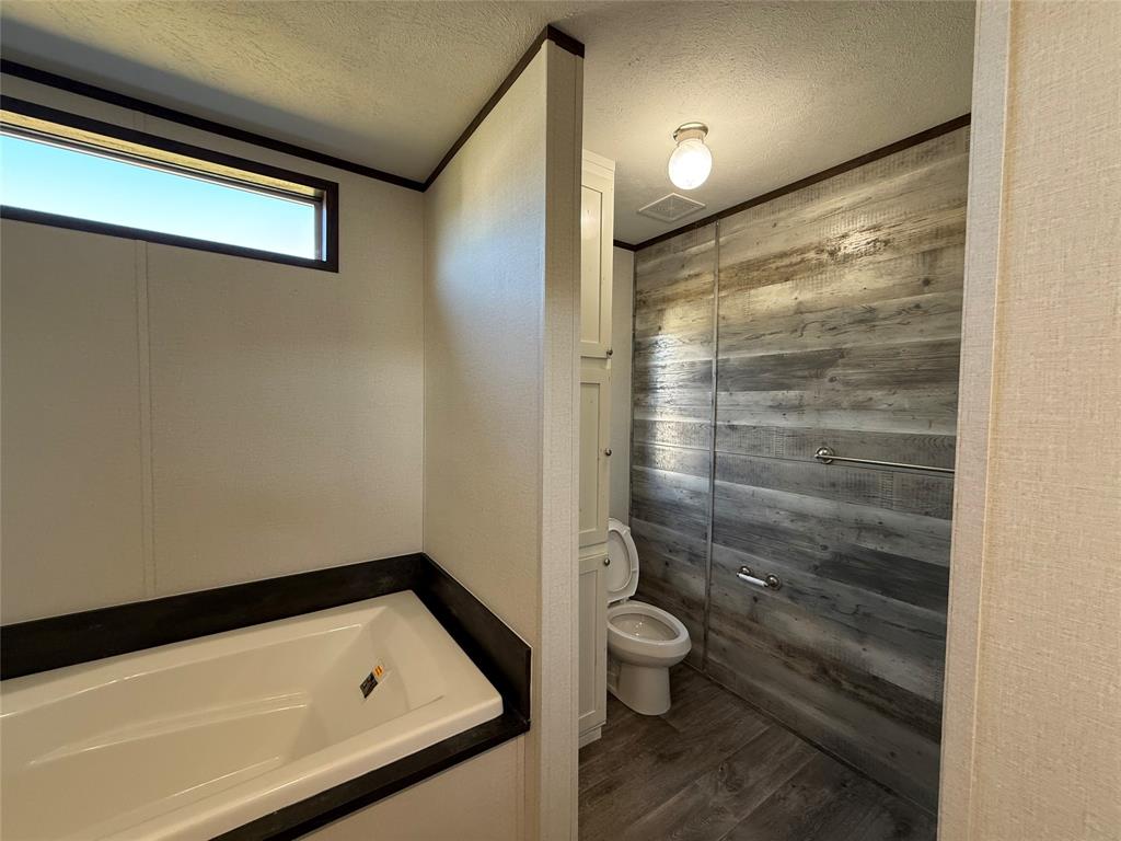 439 Whitefoot Quitman, TX 75783 - Photo 18 of 35 a bathroom with a toilet and a shower
