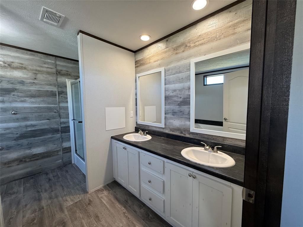 439 Whitefoot Quitman, TX 75783 - Photo 19 of 35 a bathroom with a double vanity sink and mirror