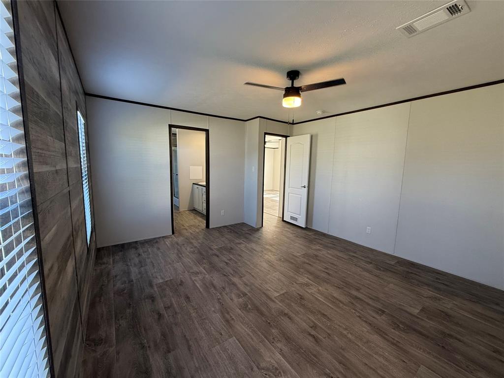 439 Whitefoot Quitman, TX 75783 - Photo 20 of 35 an empty room with wooden floor and windows