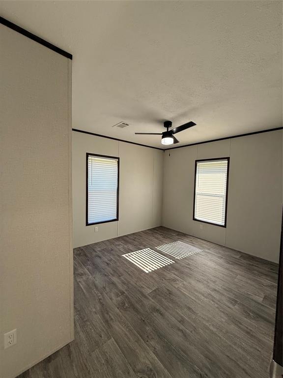 439 Whitefoot Quitman, TX 75783 - Photo 22 of 35 an empty room with windows and fan