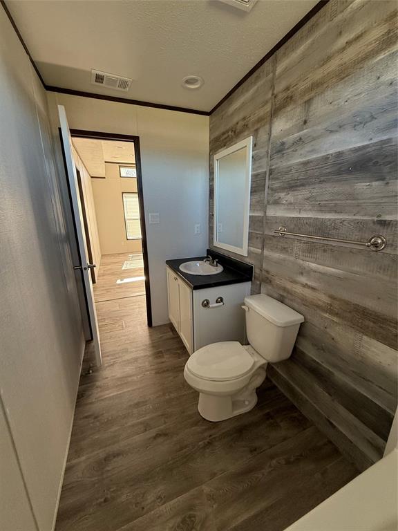 439 Whitefoot Quitman, TX 75783 - Photo 24 of 35 a bathroom with a granite countertop toilet a sink and a mirror