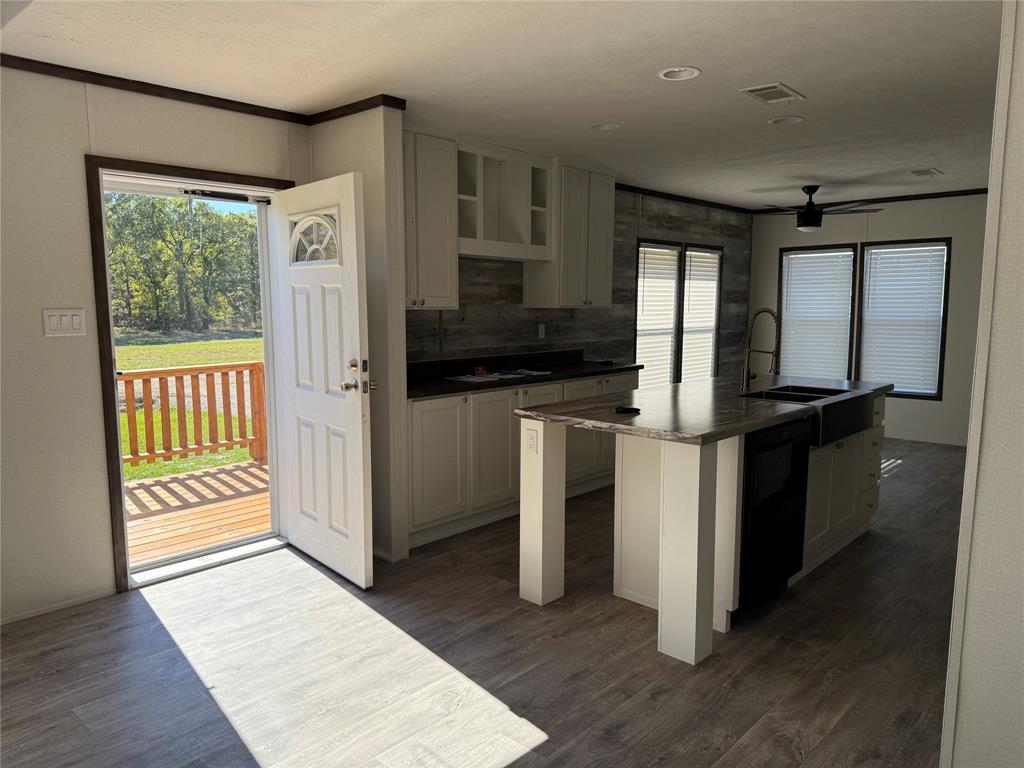 439 Whitefoot Quitman, TX 75783 - Photo 27 of 35 a kitchen with granite countertop a refrigerator and a sink