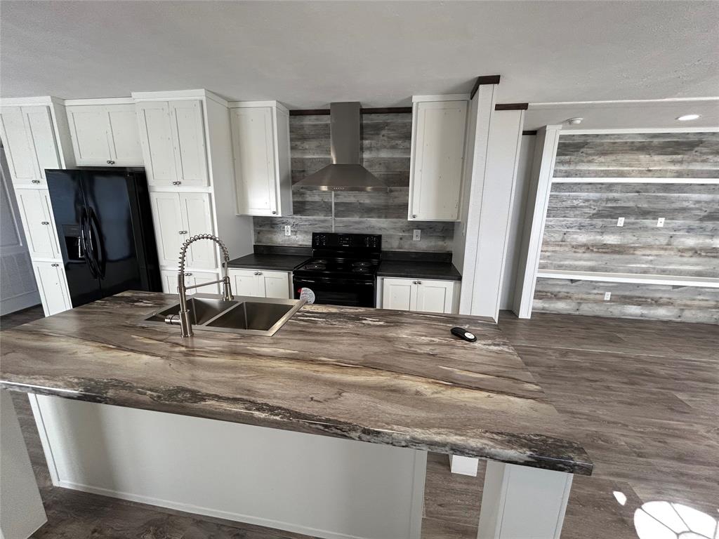 439 Whitefoot Quitman, TX 75783 - Photo 31 of 35 a view of a kitchen with granite countertop a sink and a stove top oven