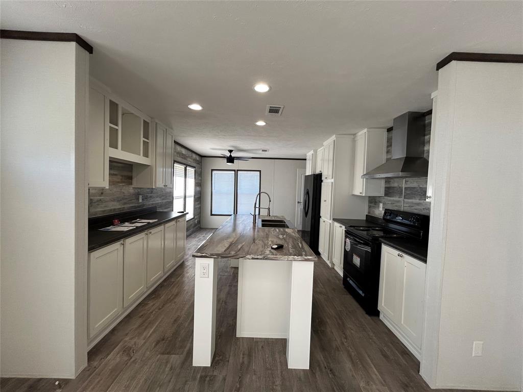439 Whitefoot Quitman, TX 75783 - Photo 32 of 35 a kitchen with granite countertop a stove sink and refrigerator