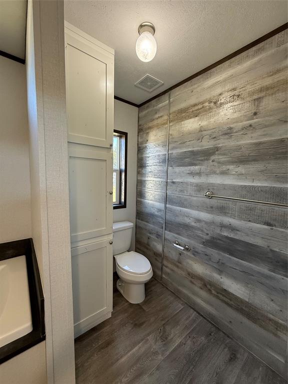 439 Whitefoot Quitman, TX 75783 - Photo 33 of 35 a bathroom with a toilet and a shower
