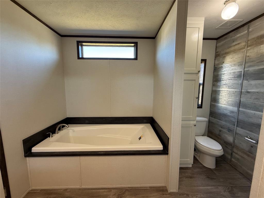 439 Whitefoot Quitman, TX 75783 - Photo 34 of 35 a bathroom with a granite countertop sink and a toilet