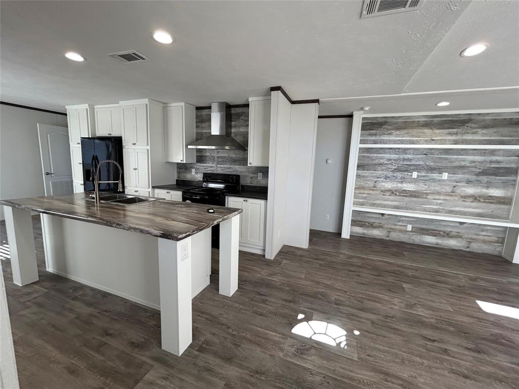 439 Whitefoot Quitman, TX 75783 - Photo 5 of 35 a kitchen with granite countertop a refrigerator and a stove top oven