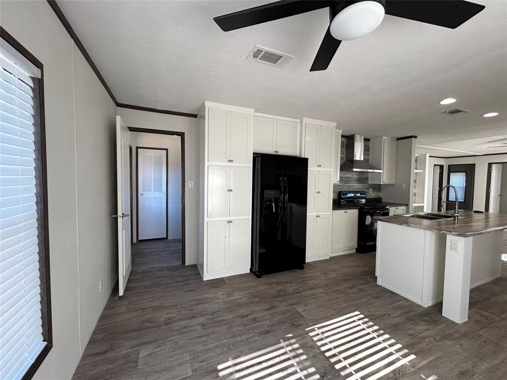 439 Whitefoot Quitman, TX 75783 - Photo 8 of 35 a kitchen with stainless steel appliances kitchen island granite countertop a refrigerator and a sink