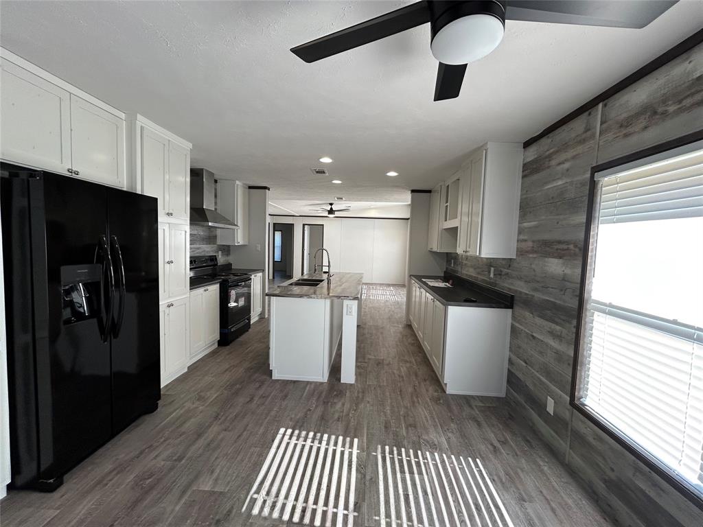 439 Whitefoot Quitman, TX 75783 - Photo 9 of 35 a kitchen with a white refrigerator cabinets and wooden floor