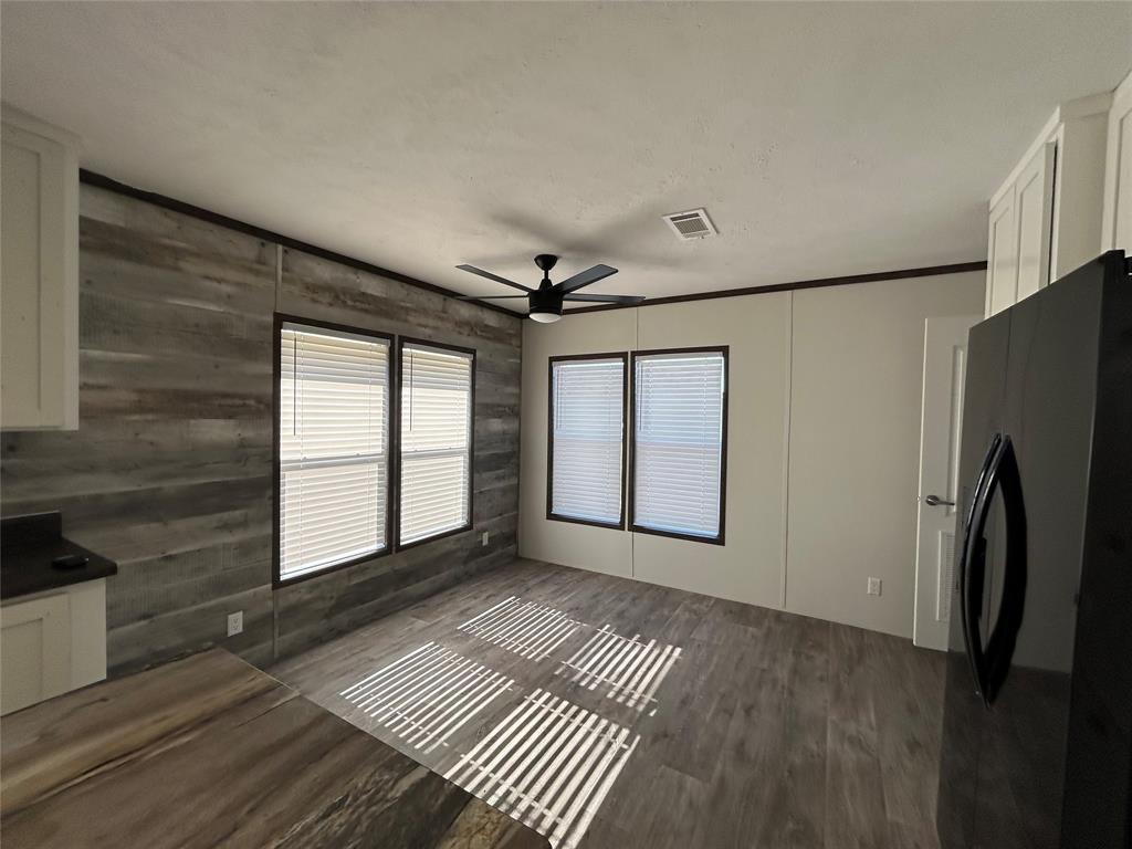 439 Whitefoot Quitman, TX 75783 - Photo 10 of 35 a view of empty room with wooden floor and fan