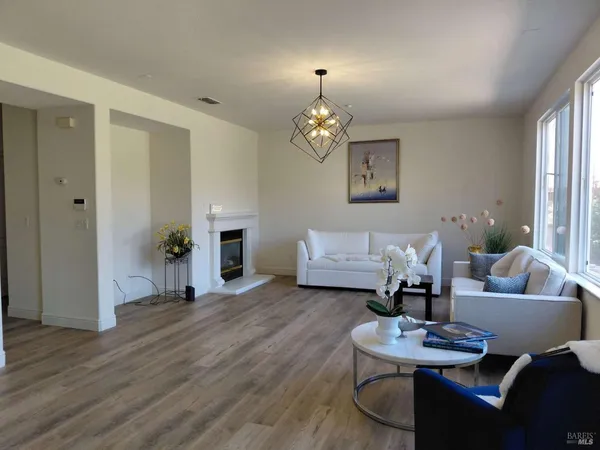 a living room with furniture window and wooden floor