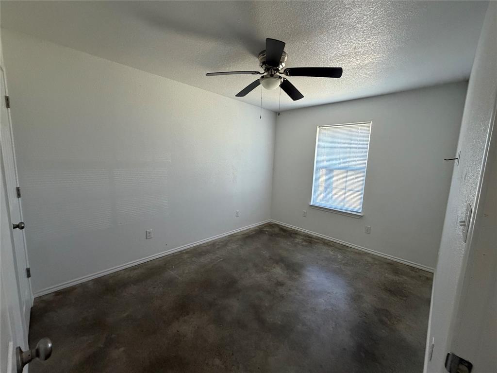 712 Seven Oaks Road, Unit 712 Bonham, TX 75418 - Photo 10 of 14 an empty room with windows and fan