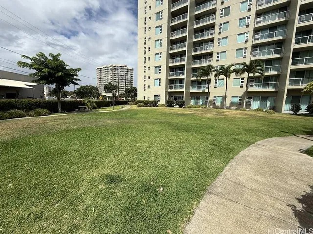 a front view of a building with a garden