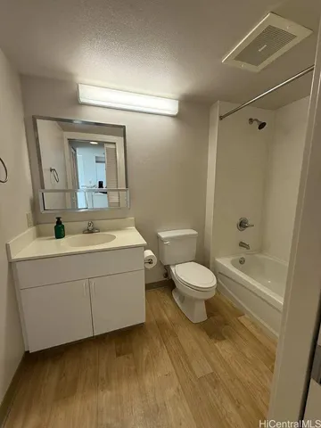 a bathroom with a sink mirror toilet and bathtub